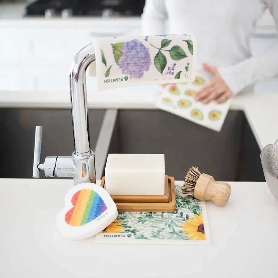 Kitchen cloths,sponge, soap and dish brush near sink